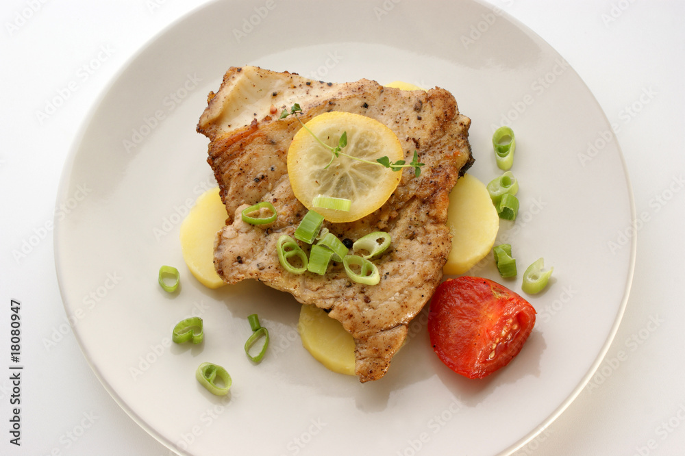 carp steak with potato and organic tomato