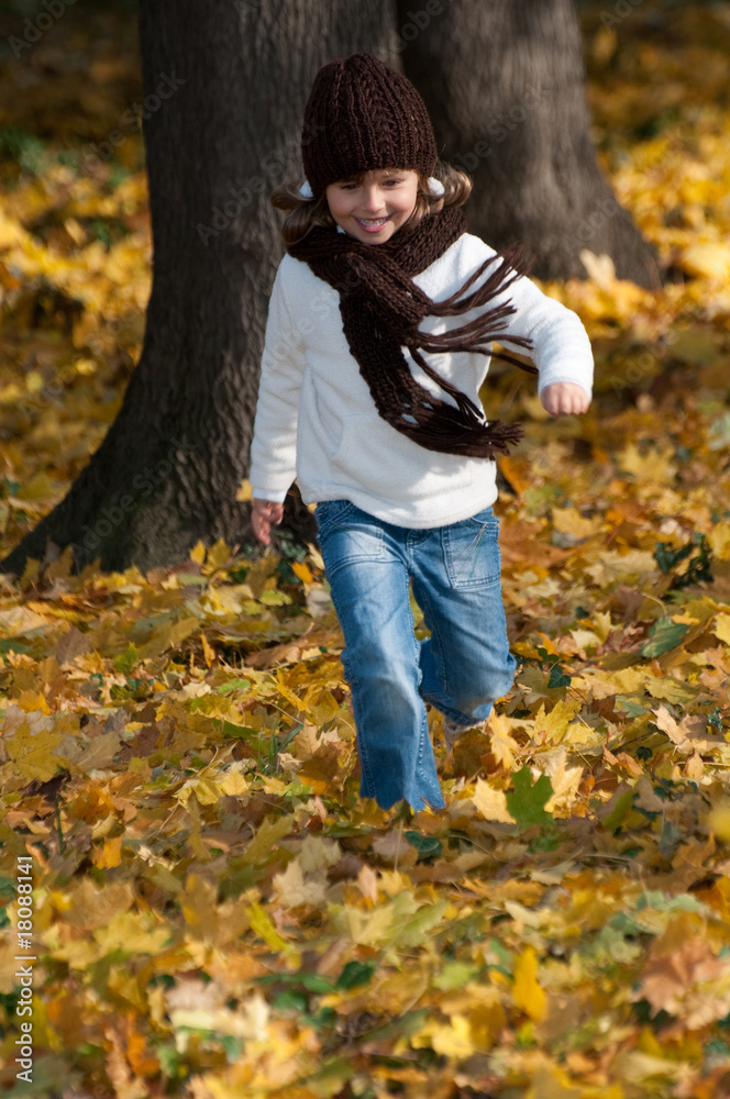Little girl running in autumn park Little girl running in autumn park