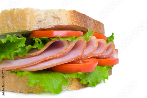 sandwich with sliced ham, tomatoes and lettuce leaves