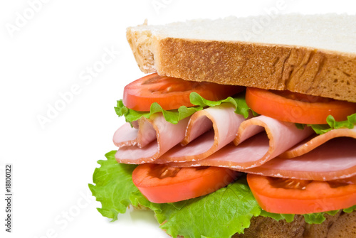 sandwich with sliced ham, tomatoes and lettuce leaves