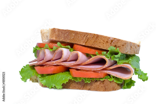 sandwich with sliced ham, tomatoes and lettuce leaves
