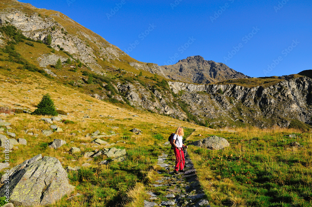 female trekker looking in camera in mountain landscape