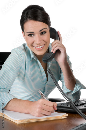 Young businesswoman on the phone at work, isolated on white