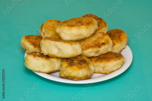 Potato cakes with meat on a green background © OlegD