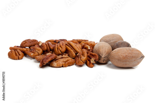 Whole and halved pecans on white