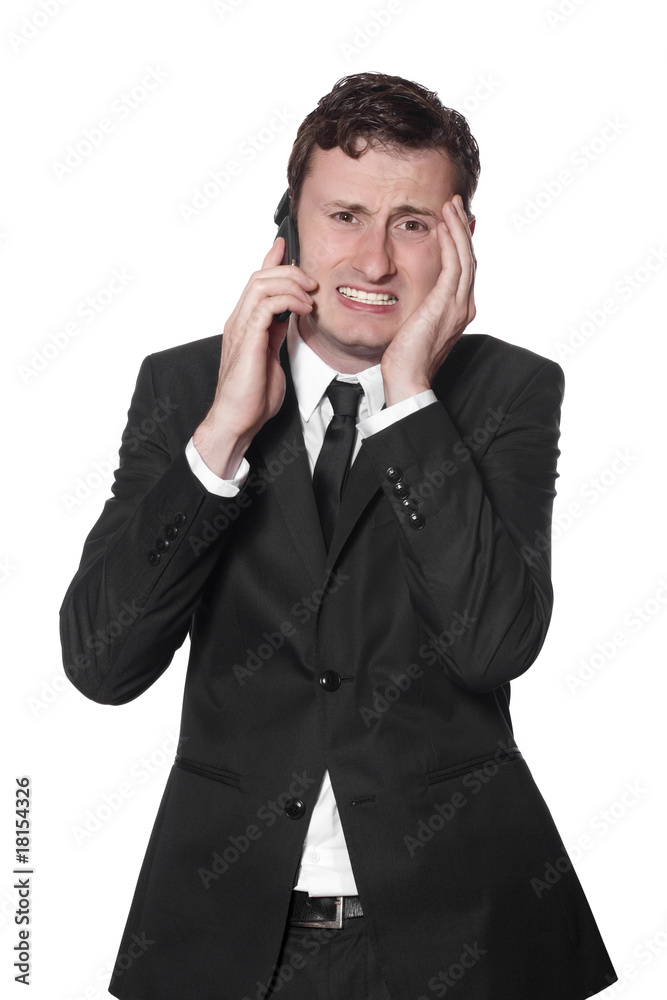 businessman with a mobile phone and headache businessman with a mobile phone and headache