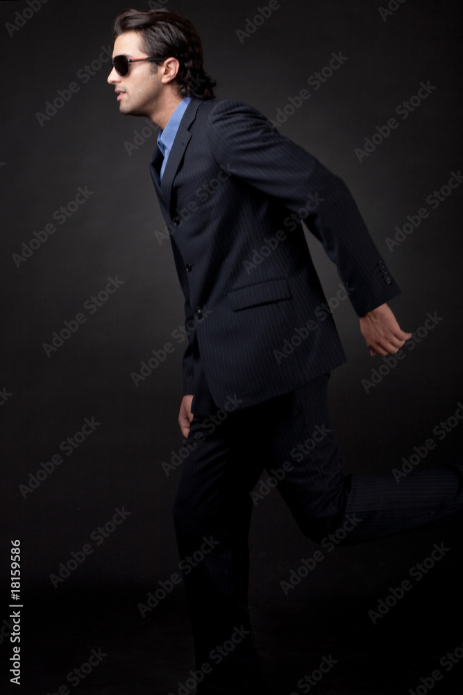 Portrait of young business man wearing a sunglass sideview