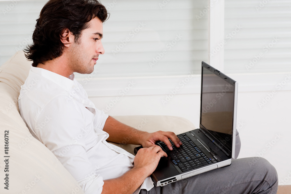 Fototapeta premium young guy doing work at home