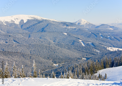 winter mountain landscape with alpine skiing tracks cuttings in