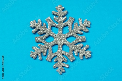 snowflake on blue background © Elkostas