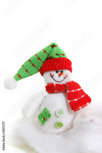 toy snowman in snow over white