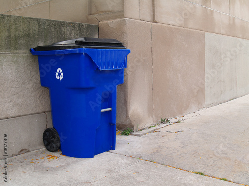 Large Blue Trash Can on a City Sidewalk photo