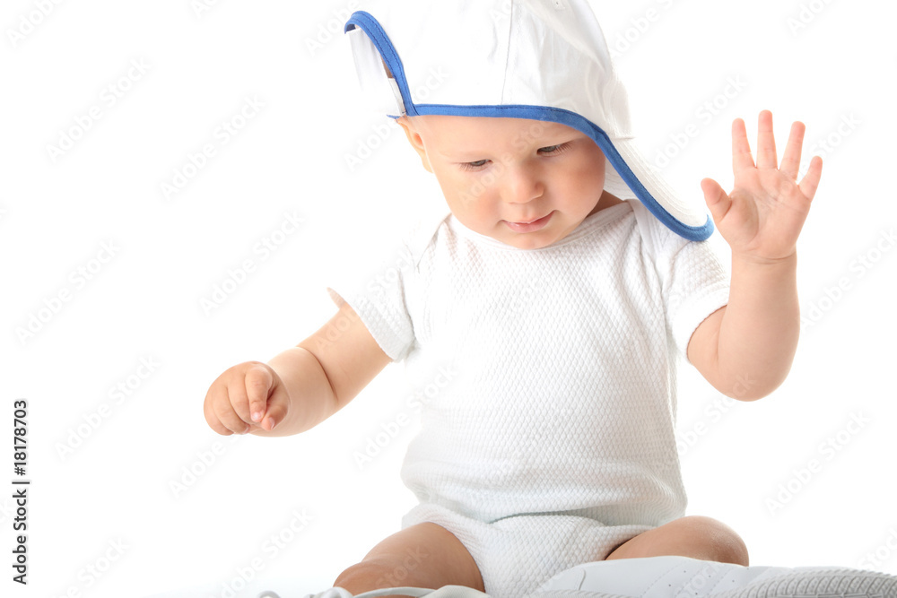 Baby trying on shoes and basebal cap Baby trying on shoes and basebal cap