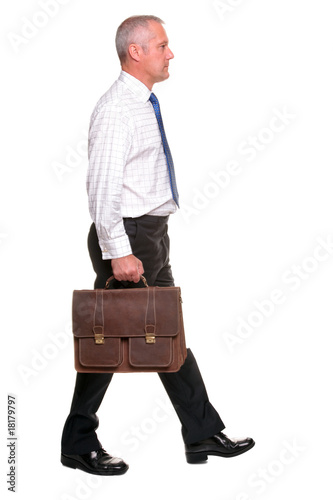 Mature businesman walking, side view. photo