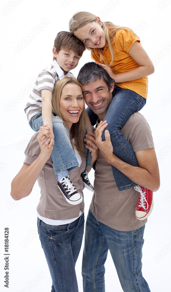Fototapeta premium Mother and father giving children piggyback ride