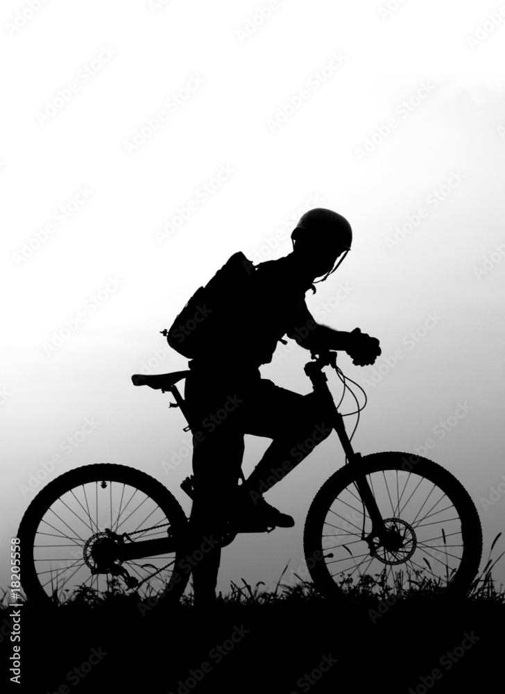 Obraz premium adventure cycling in the nature - mountain biker silhouette