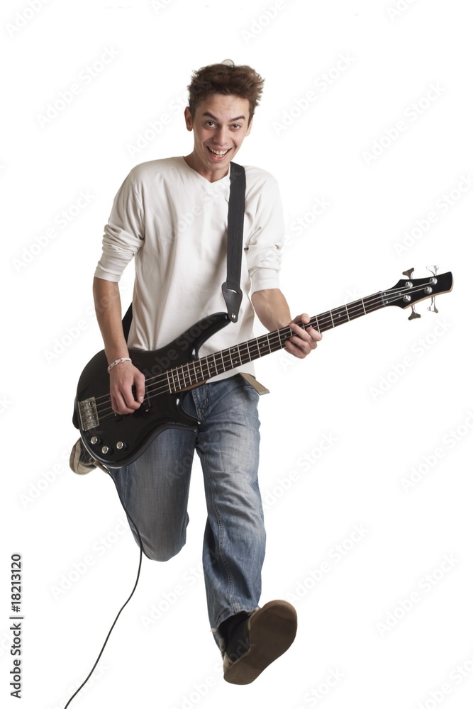 The young guy with a bass guitar in a jump.