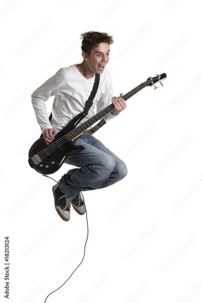 Naklejka premium The young guy with a bass guitar in a jump.