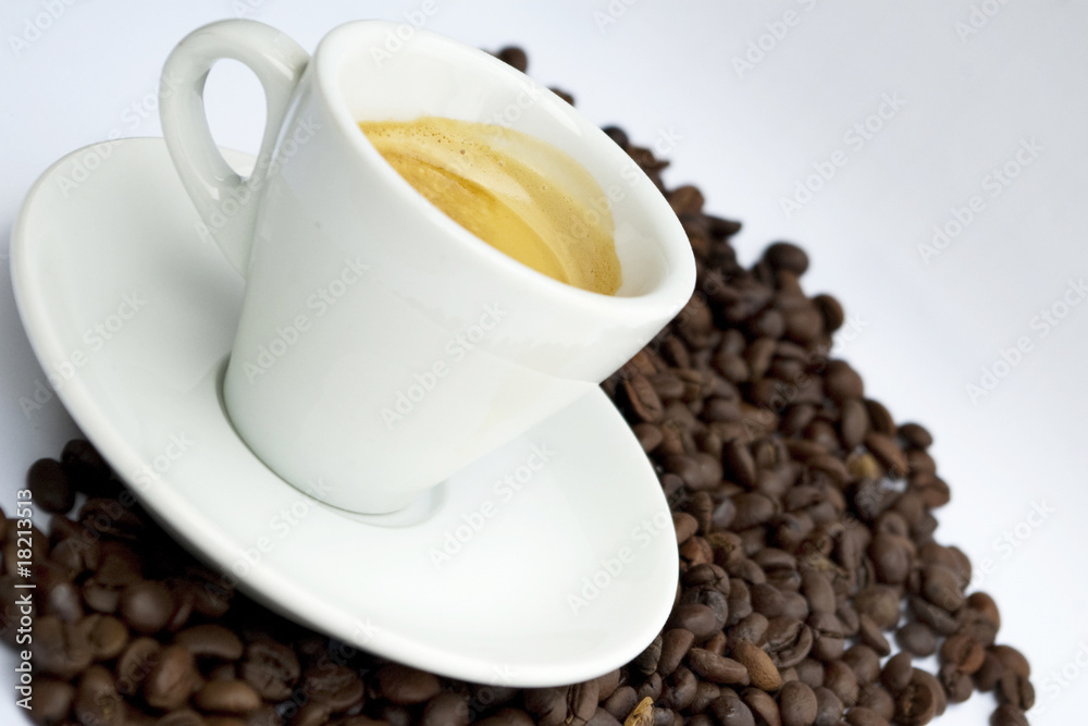 Cup of coffee sitting in a bed of coffee beans Cup of coffee sitting in a bed of coffee beans