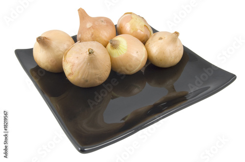 Wallpaper Mural baby onions on black plate isolated on white background Torontodigital.ca