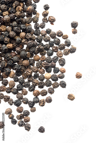 Close up of black peppercorns in isolated white background