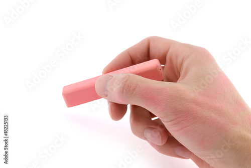 Hand with pink chalk writing on a white background