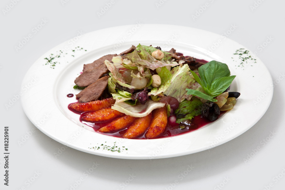 Salad from duck meat, oranges, leaves of salad and nuts and sauc Salad from duck meat, oranges, leaves of salad and nuts and sauc