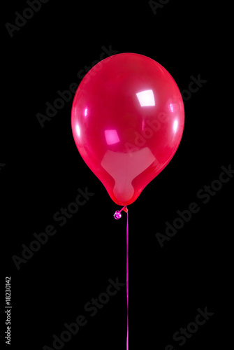 Red party balloon on black