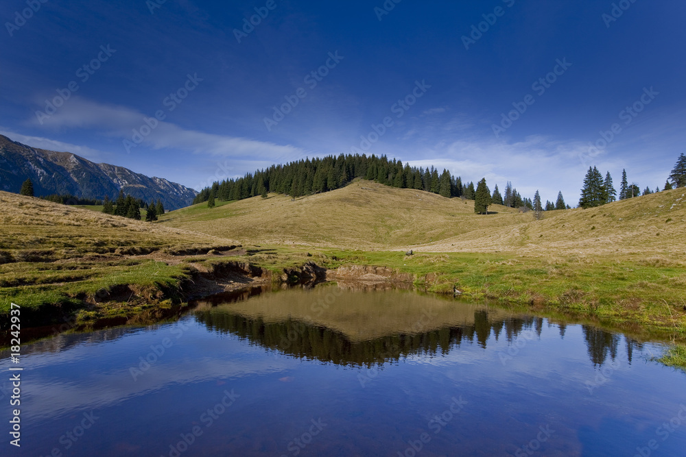 Beautiful autumn scenery in the mountains with lake reflection