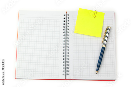 note and pen on a notebook