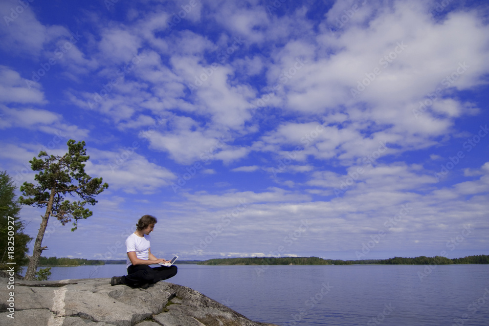 Man with a laptop in an outdoor Man with a laptop in an outdoor