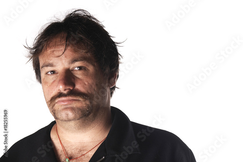 Self confident Man with stylish moustache, in a photo studio