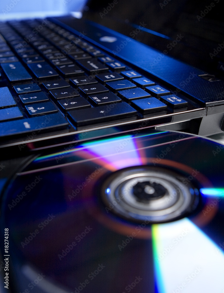 The laptop with a colorfull compact disc. The laptop with a colorfull compact disc.