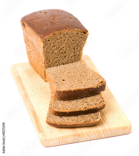 Brown bread on cutting board isolated on white