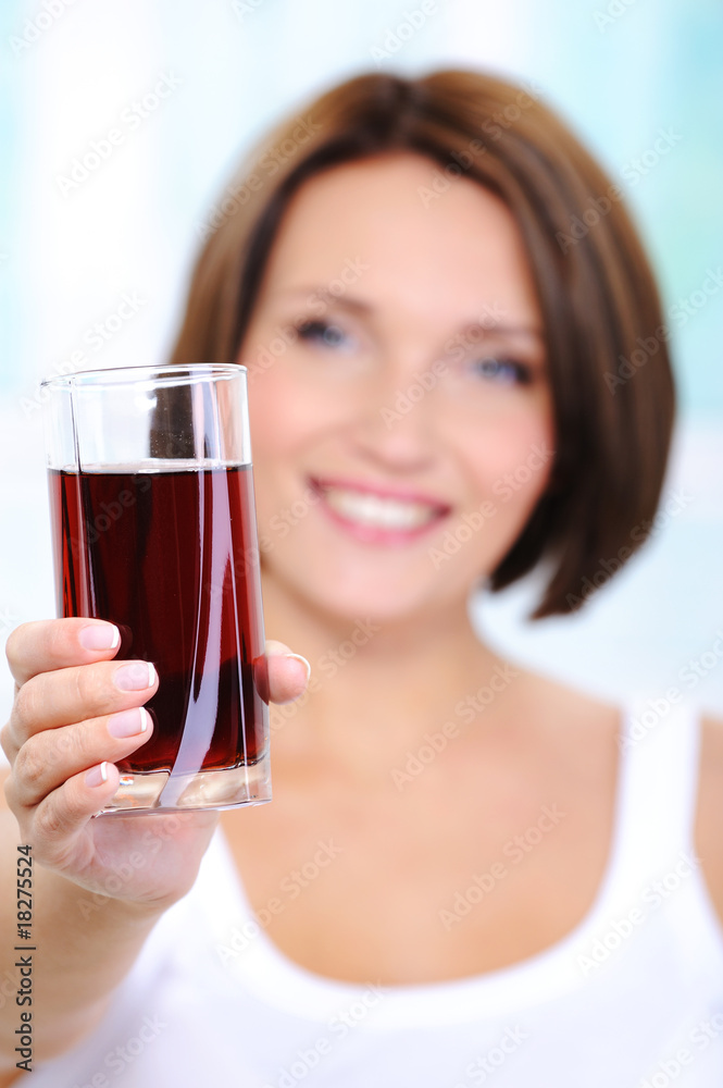 beautiful young woman holds a glass of cherry juice beautiful young woman holds a glass of cherry juice