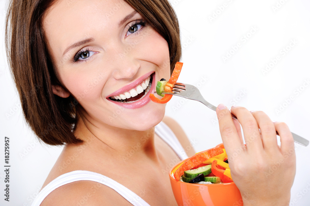 happy attractive woman eats vegetable salad happy attractive woman eats vegetable salad