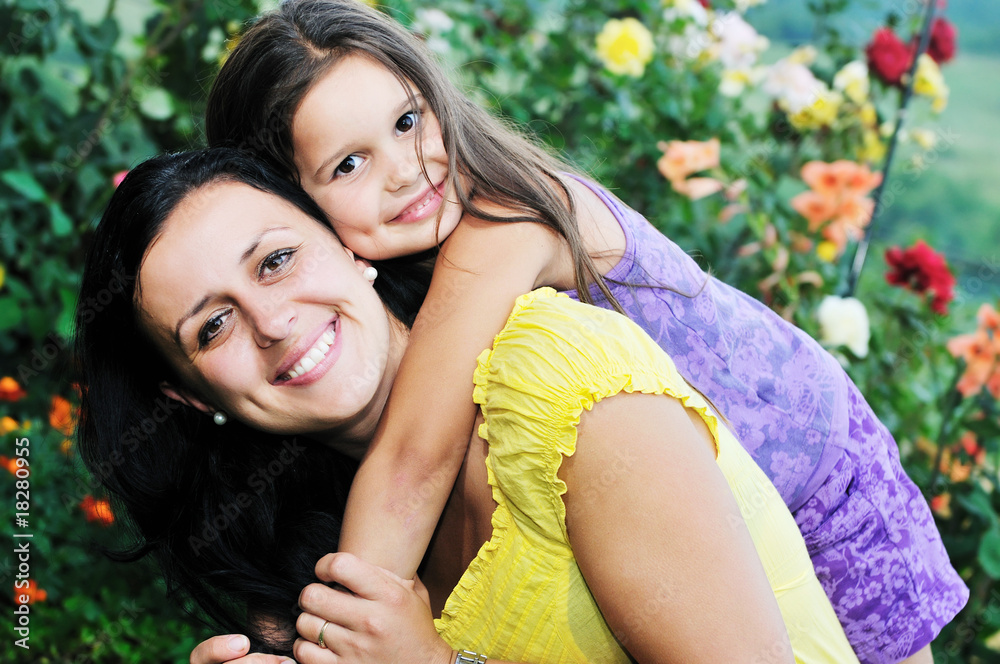 Naklejka premium happy mom and daughter outdoor