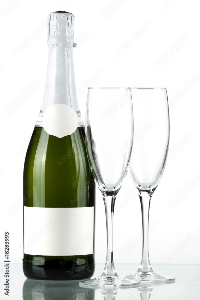 Bottle of champagne with blank label and with two empty glasses Bottle of champagne with blank label and with two empty glasses