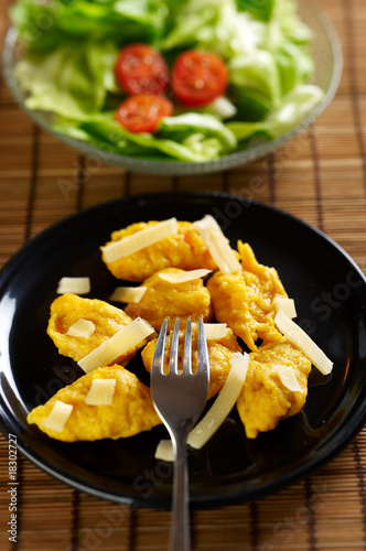 Gnocchi made of pumpkin with sliced cheese