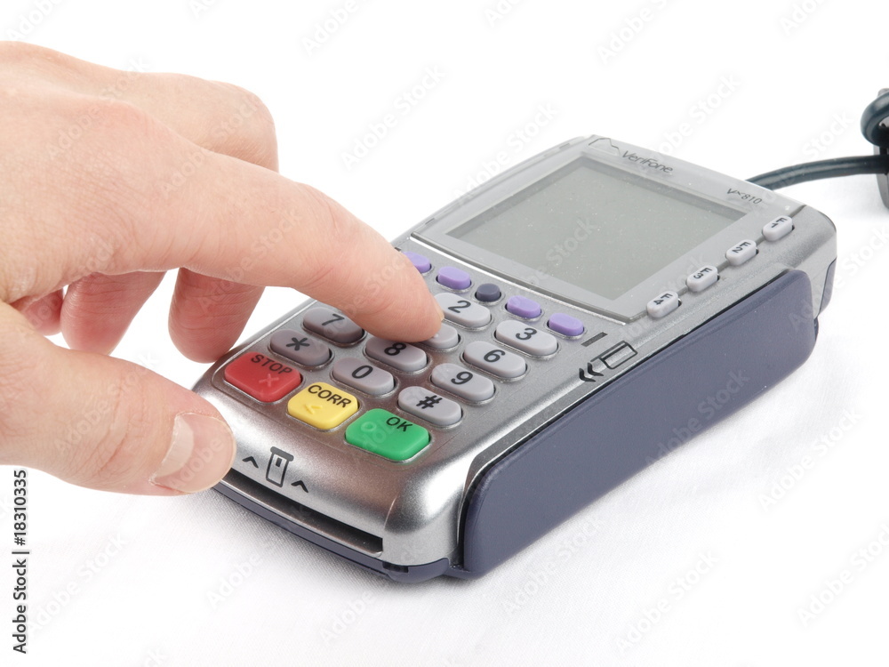 Payment terminal - a finger entering the PIN code Payment terminal - a finger entering the PIN code