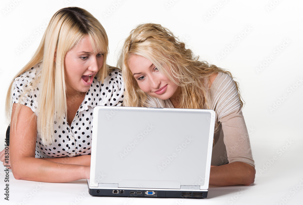 Happy young women looking excited in their laptop
