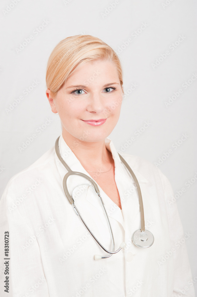 Young optimistic female doctor in uniform with stethoscope Young optimistic female doctor in uniform with stethoscope