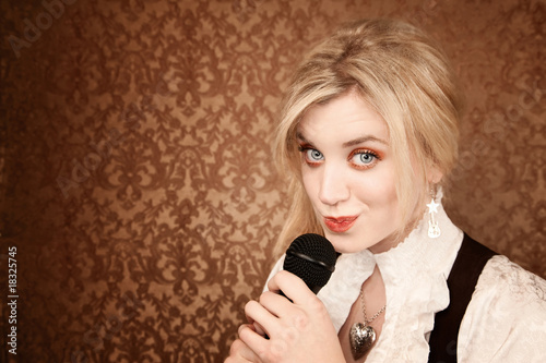 Fotografia Pretty young singer or comedian with microphone