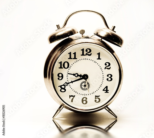 Old alarm clock isolated, photo in retro style