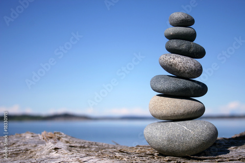 Rocks balancing on log