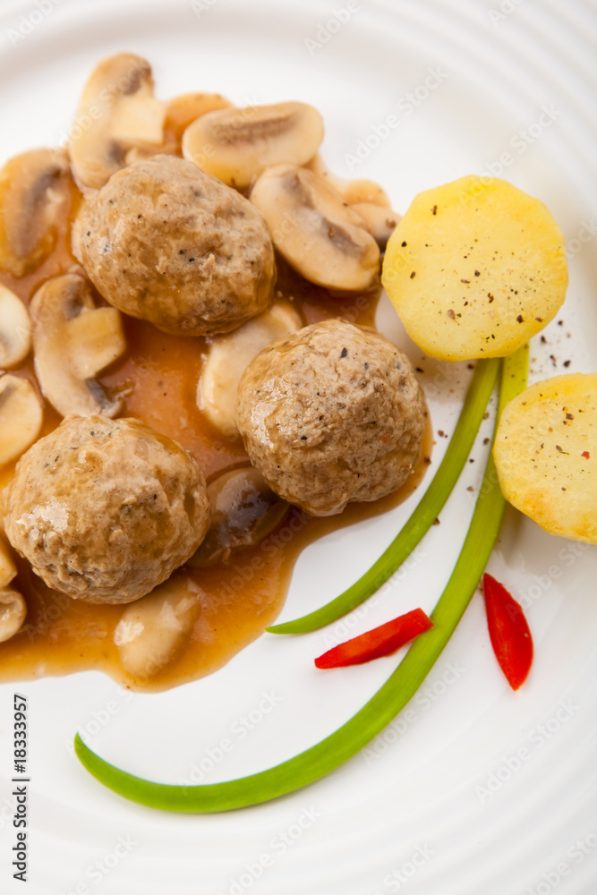 Roasted meatballs with mushrooms and boiled potatoes