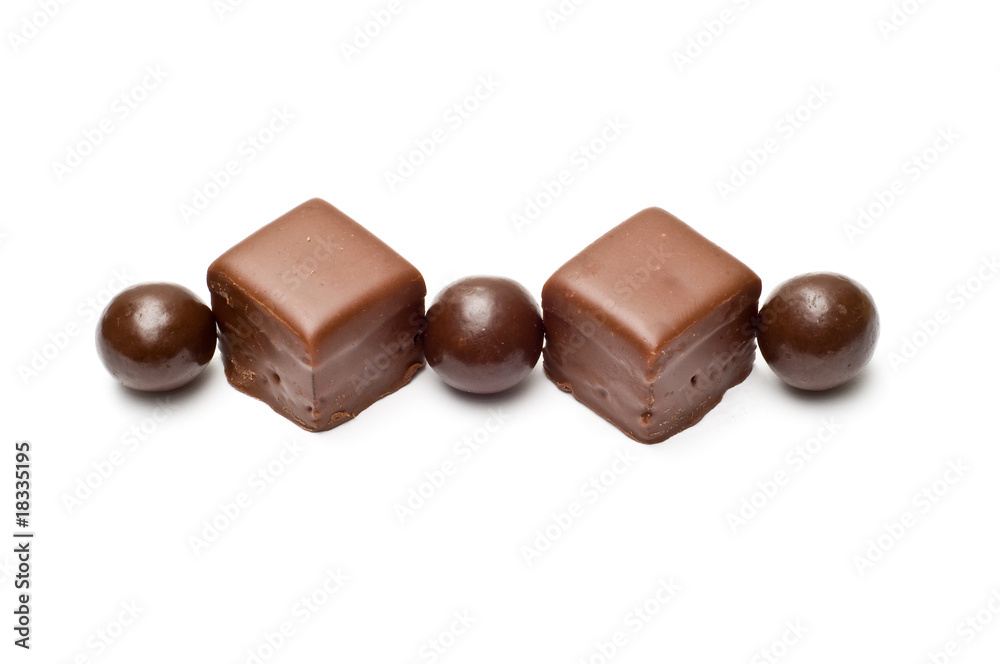 Lined chocolate balls and cubes top view Lined chocolate balls and cubes top view