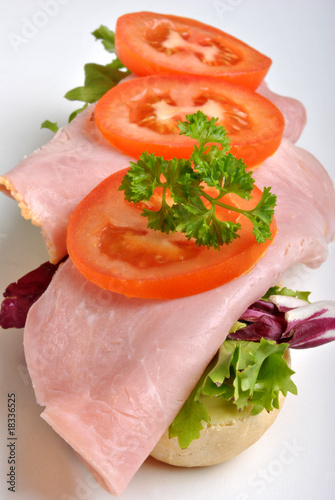 bread roll with ham and organic tomato