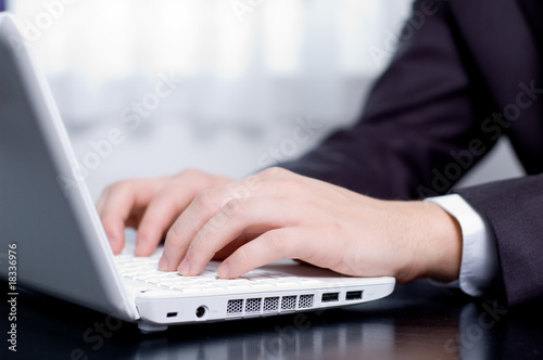 Businessman typing on a notebook (shallow DOF)