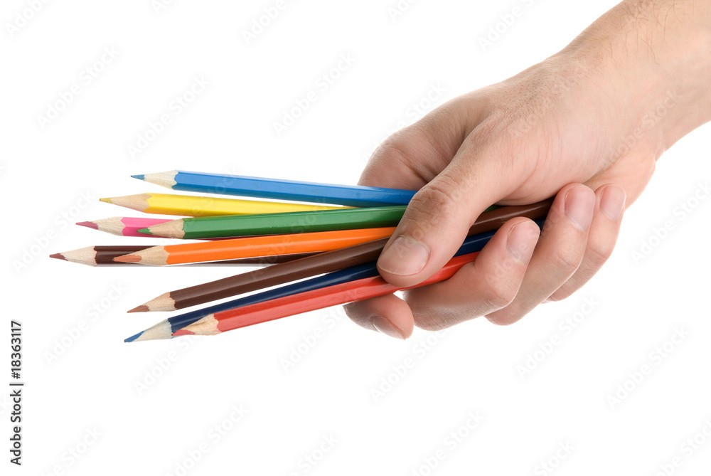 Naklejka premium Hands with colored pencils over white